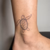 Small sea turtle tattoo design with fine line shell details, swimming flippers, and subtle dotwork