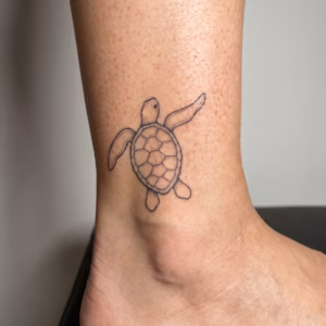 Small sea turtle tattoo design with fine line shell details, swimming flippers, and subtle dotwork